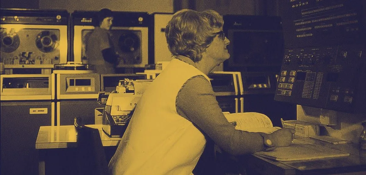 A woman looking at an old computer