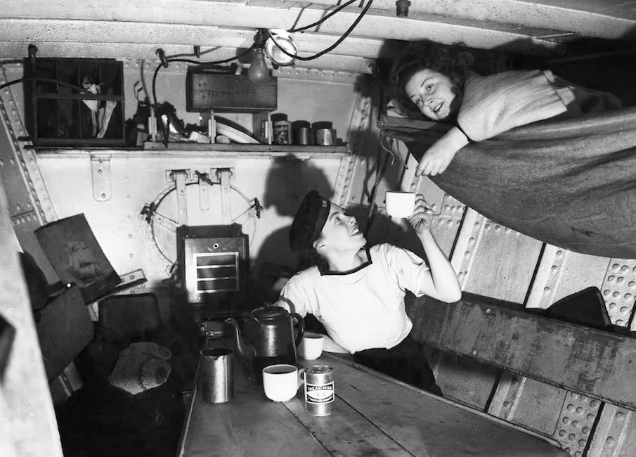 Wrens Hazel Morris and Gladys Carter on board a duty boat in Plymouth, 20 November 1944. 