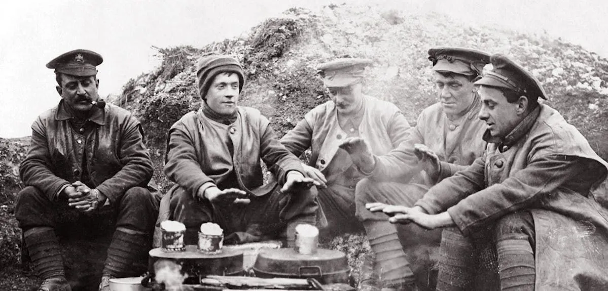 First World War soldiers gathered around a camp fire.