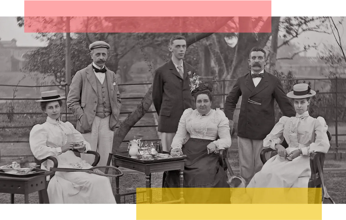 Couples sitting and standing at a tennis match