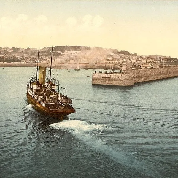 A boat arriving at St Peter’s Port in Guernsey circa 1890 