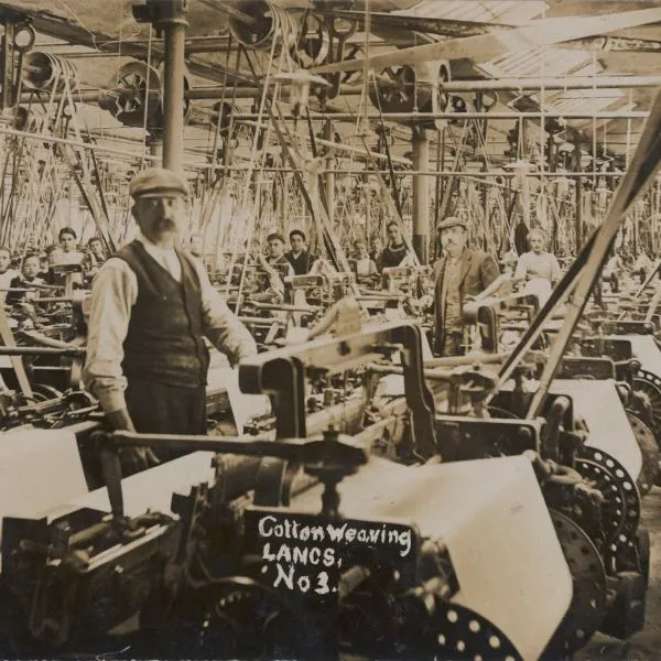 A black-and-white photograph of a cotton weaving factory in Lancashire